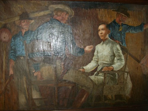 Obra maestra na nagpapakita kay Mabini sa ilalim ng kustodiya ng mga Amerikano.  Makasabit sa Dambanang Pangkasaysayang Mabini sa Tanauan, Batangas