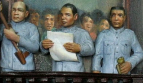 Pagwagayway ni Ambrosio Rianzares Bautista ng watawat.  Mula sa Ayala Museum The Diorama Experience.