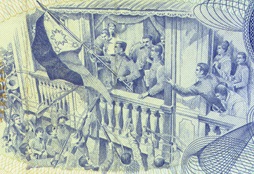 Pagwagayway ni Heneral Aguinaldo sa watawat mula sa gitnang bintana ng kanyang bahay.  Nasa likuran ng dating Dalawang Pisong papel ng seryeng Bagong Lipunan.  Mula sa Bangko Sentral ng Pilipinas.