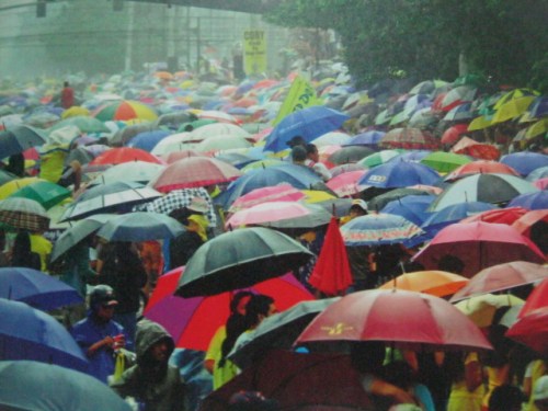 Naroon kahit naulan.  Mula sa Cory Magic:  Her People's Stories.